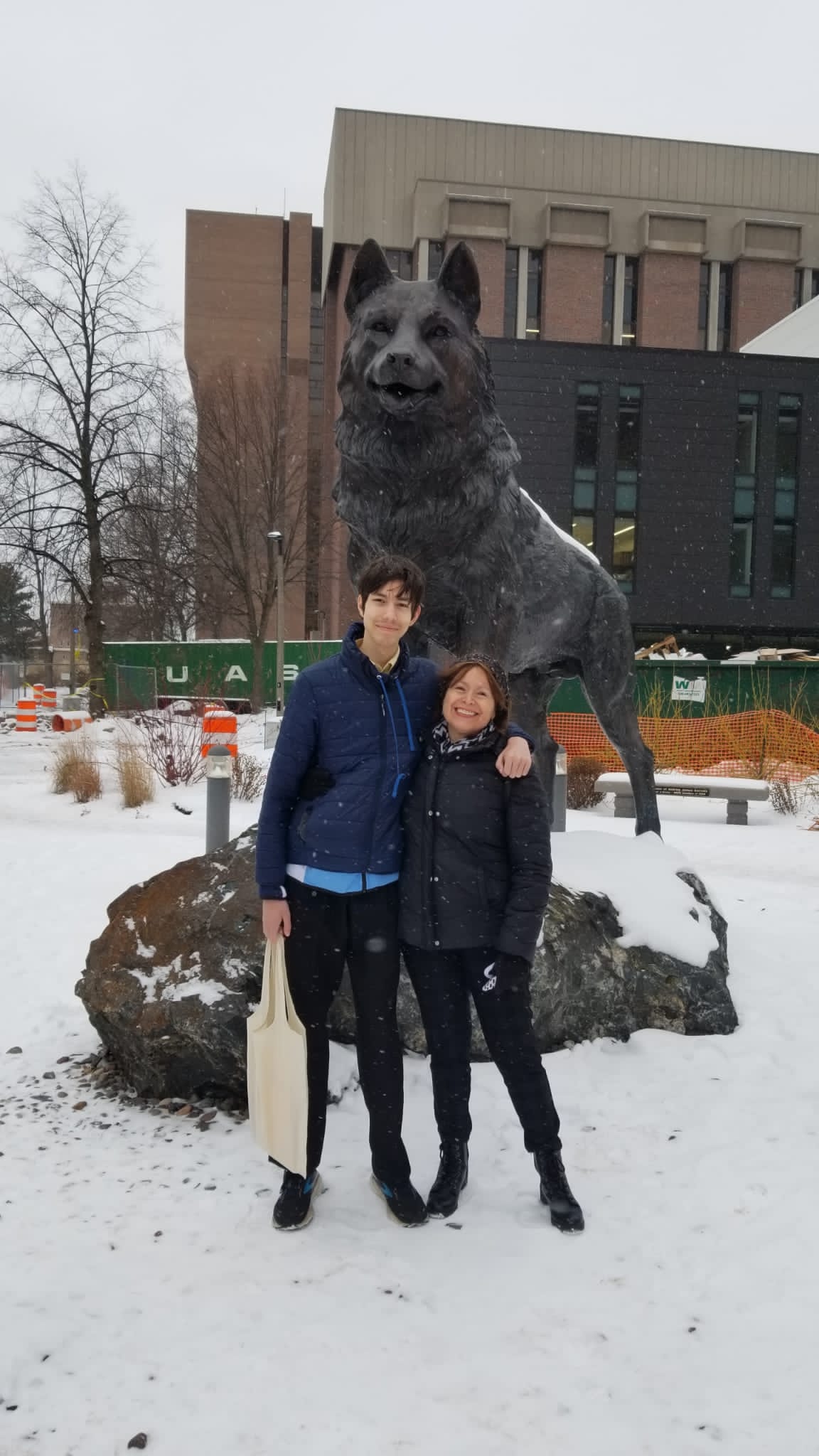 photo of me, my mom, and the Michigan Tech husky